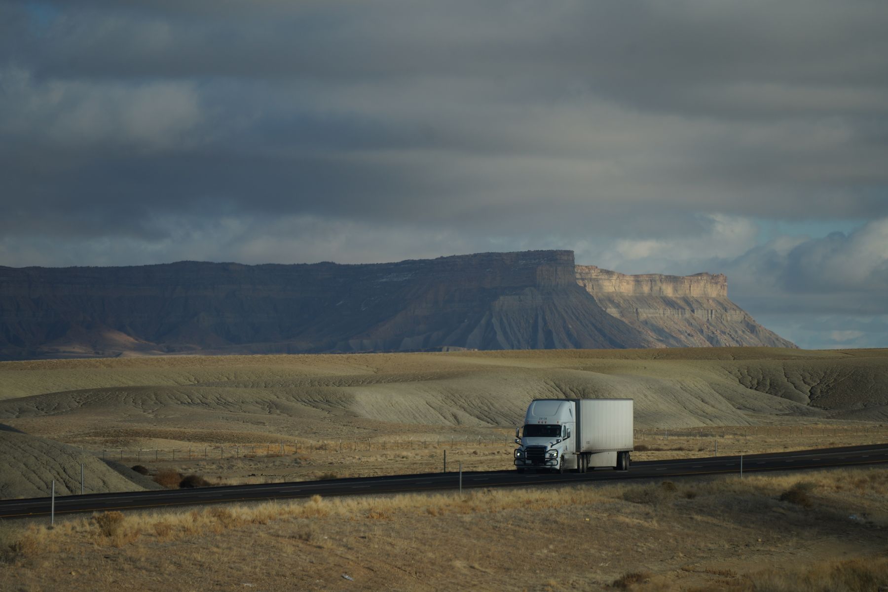 Freight truck traveling through a Southwestern desert landscape