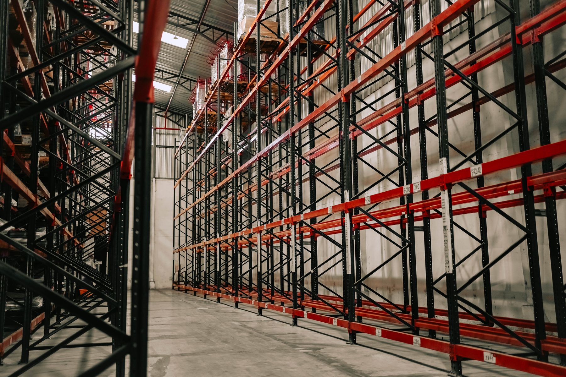 Spacious warehouse interior with tall metal storage racks